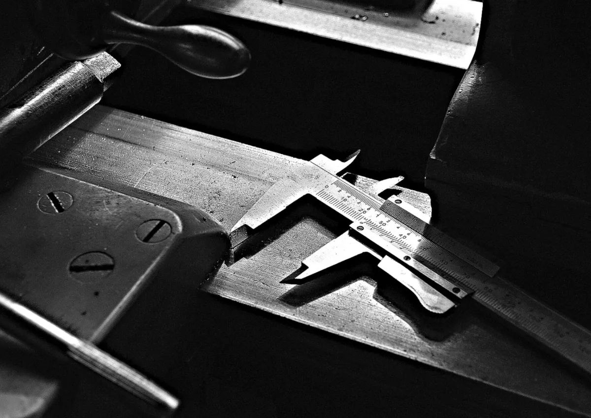 Close-up of a precision caliper tool measuring a metal part.