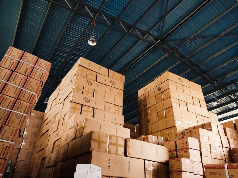 Stacked inventory boxes on warehouse shelving, photographed at an angle.