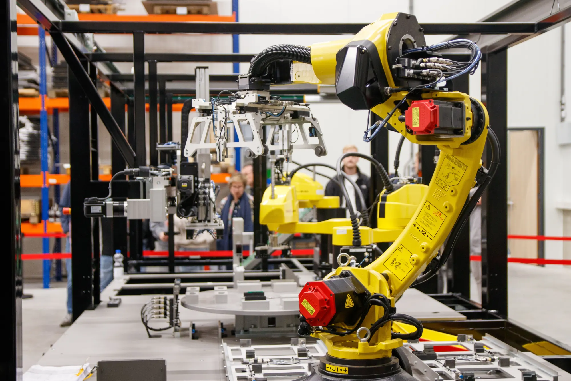 An industrial robotic arm operating on a factory floor.