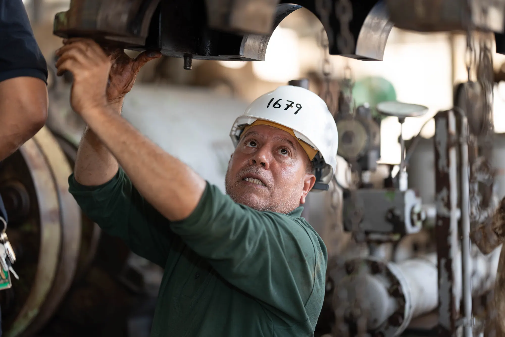 An engineer inspecting machinery in an industrial setting.